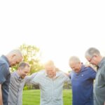 Men outdoors praying
