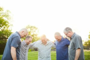 Men outdoors praying