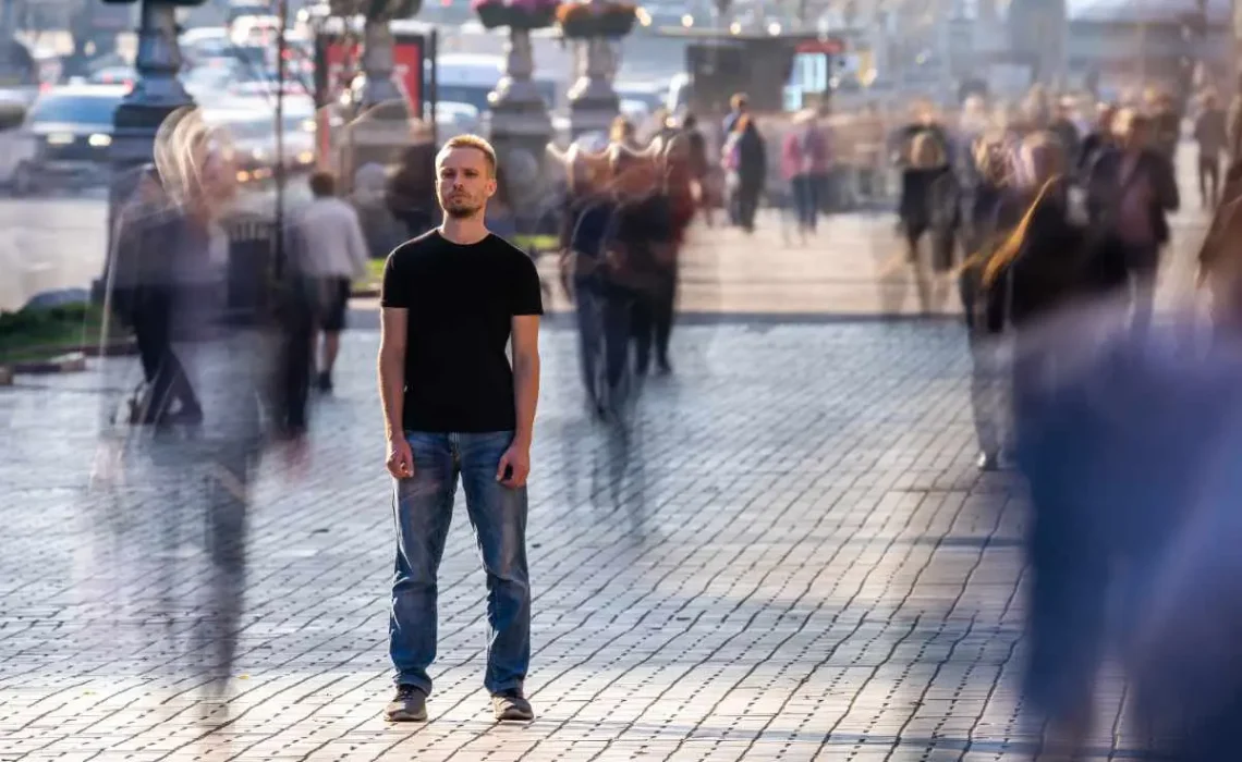 The man stands on the crowded street